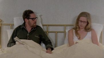 In this image from Ingmar Bergman's 1973 series Scenes from a Marriage, the characters Johan (Erland Josephson) and Marianne (Liv Ullman) are depicted together sitting in bed in their pajamas and reading glasses.