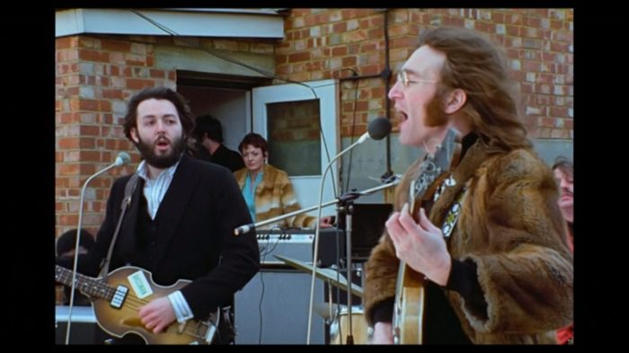 Paul McCartney and John Lennon perform on the rooftop of Apple Studios.