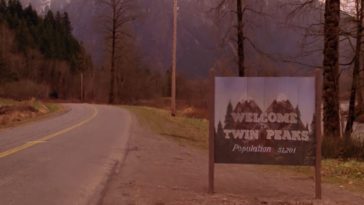 The Twin Peaks sign displays itself on a road