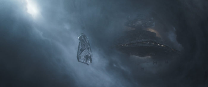 The Millennium Falcon flying away from an Imperial Star Destroyer in the background