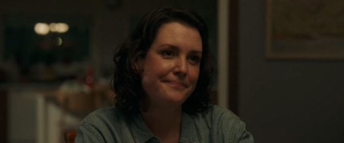 Shauna smirks as she sits at the dinner table in Yellowjackets S1E2