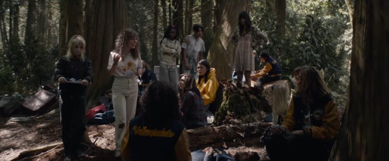 The Yellowjackets team stands in the woods after the plane crash