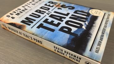 The cover displays the words "Murder at Teal's Pond" in large black text over a mostly blue image for a pond in front of trees, smoke and a mountain.