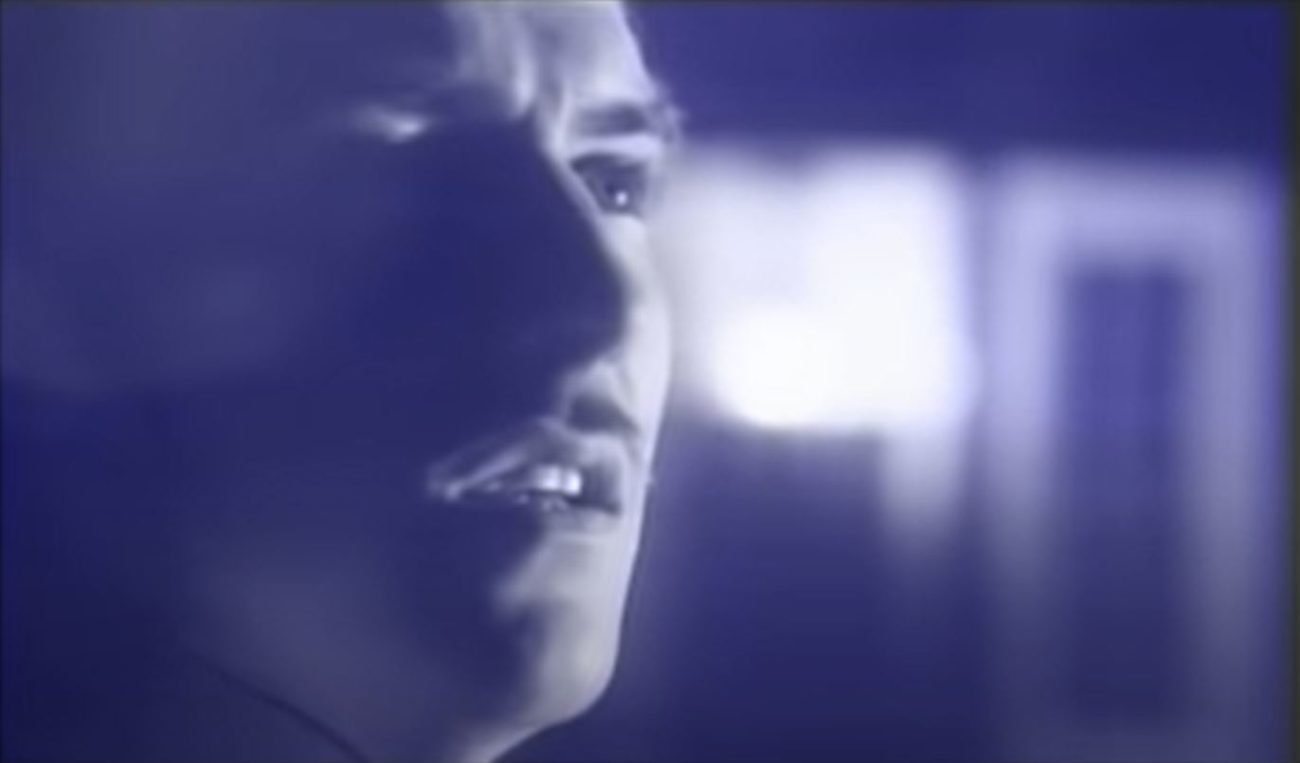The lead singer of Ultravox with a slim mustache singing in the video for "Vienna" by Ultravox