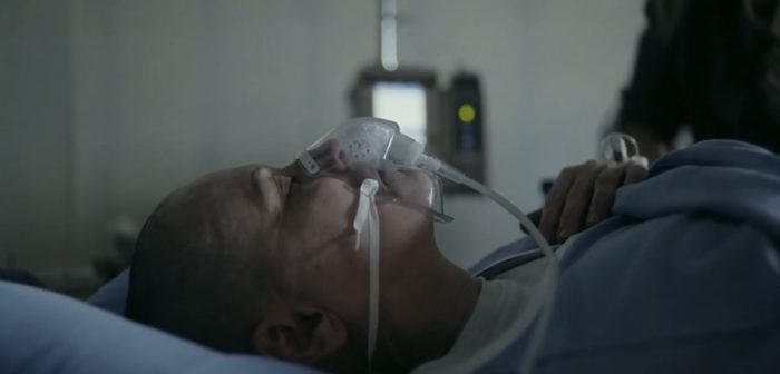 The Conductor (Lori Petty) in the hospital with the breathing apparatus attached