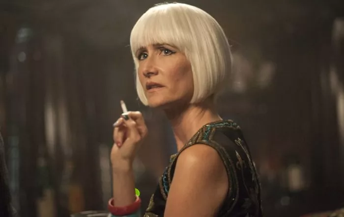 Diane (Laura Dern) in a white wig holding a cigarette, looking toward the side