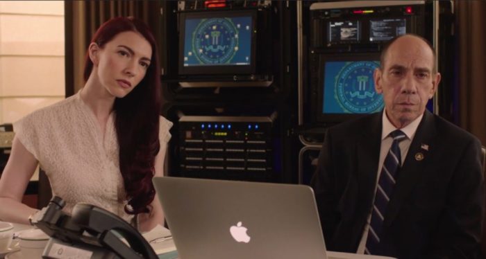 Chrysta Bell as Tammy Preston, left, sitting next to Miguel Ferrer as Albert Rosenfeld, right. Both are sitting in front of an elaborate FBI computer setup in the background