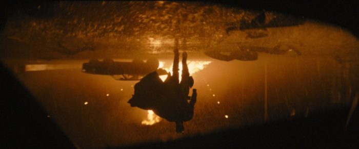 Batman is seen walking to a crash scene upside-down.