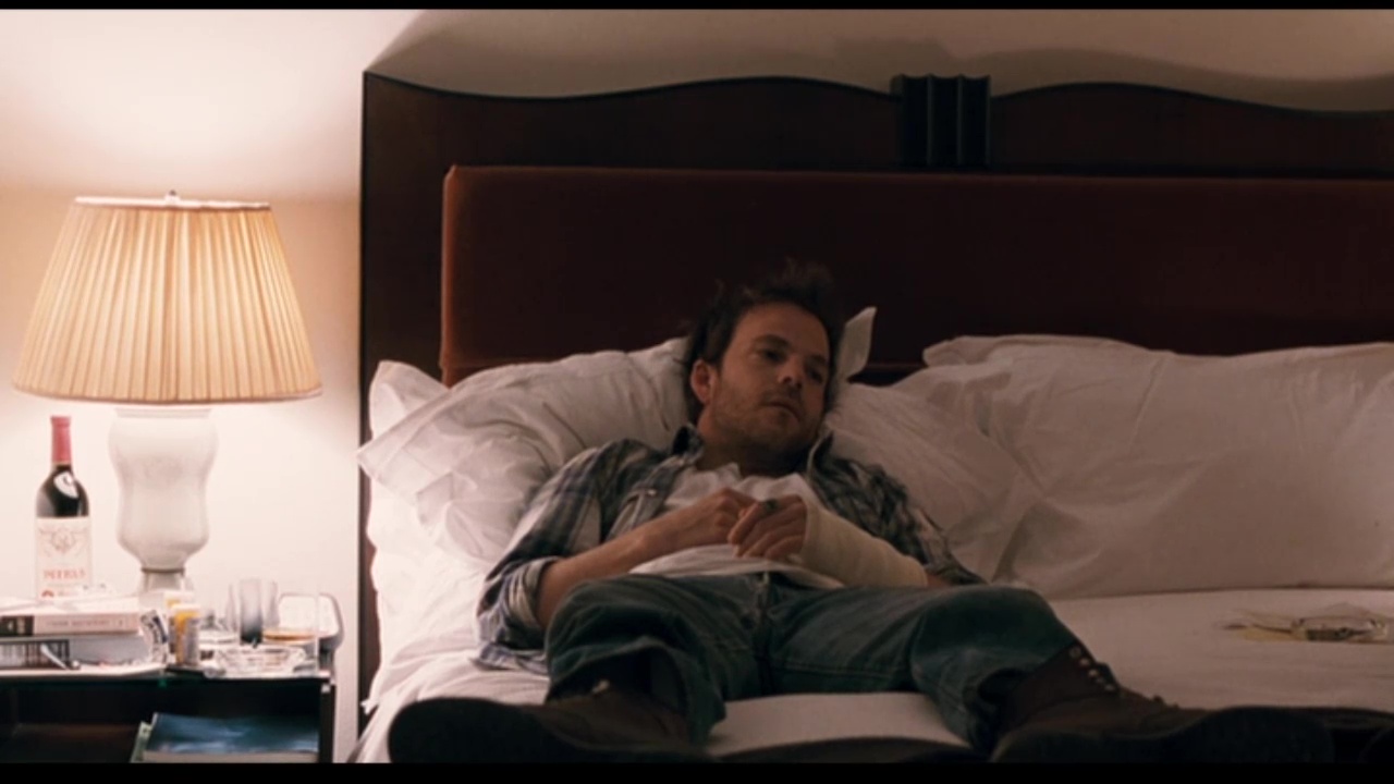 Image from Somewhere: Johnny lies in bed, wearing a cast.