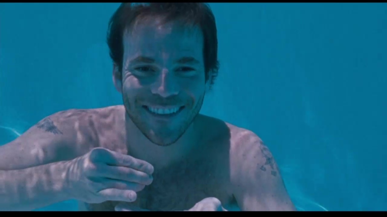 Image from Somewhere: Johnny, underwater, smiles broadly.