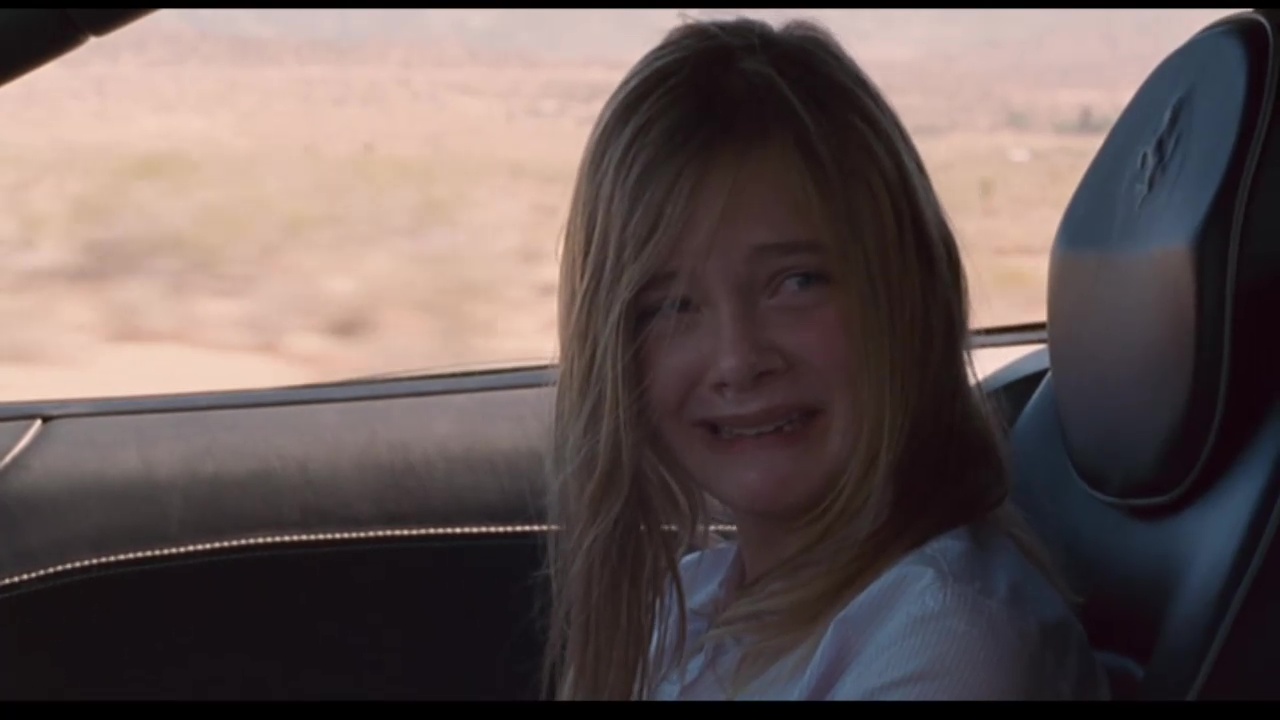 Image from Somewhere: Cleo (Fanning) cries while riding in Johnny's car.