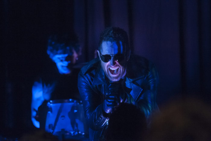 Trent Reznor of Nine Inch Nails, onstage, screaming into a microphone with a drummer in the background