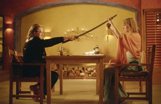 The Bride (Uma Thurman) blocks Bill's (David Carradine) sword during their final confrontation in KILL BILL VOL. 2.