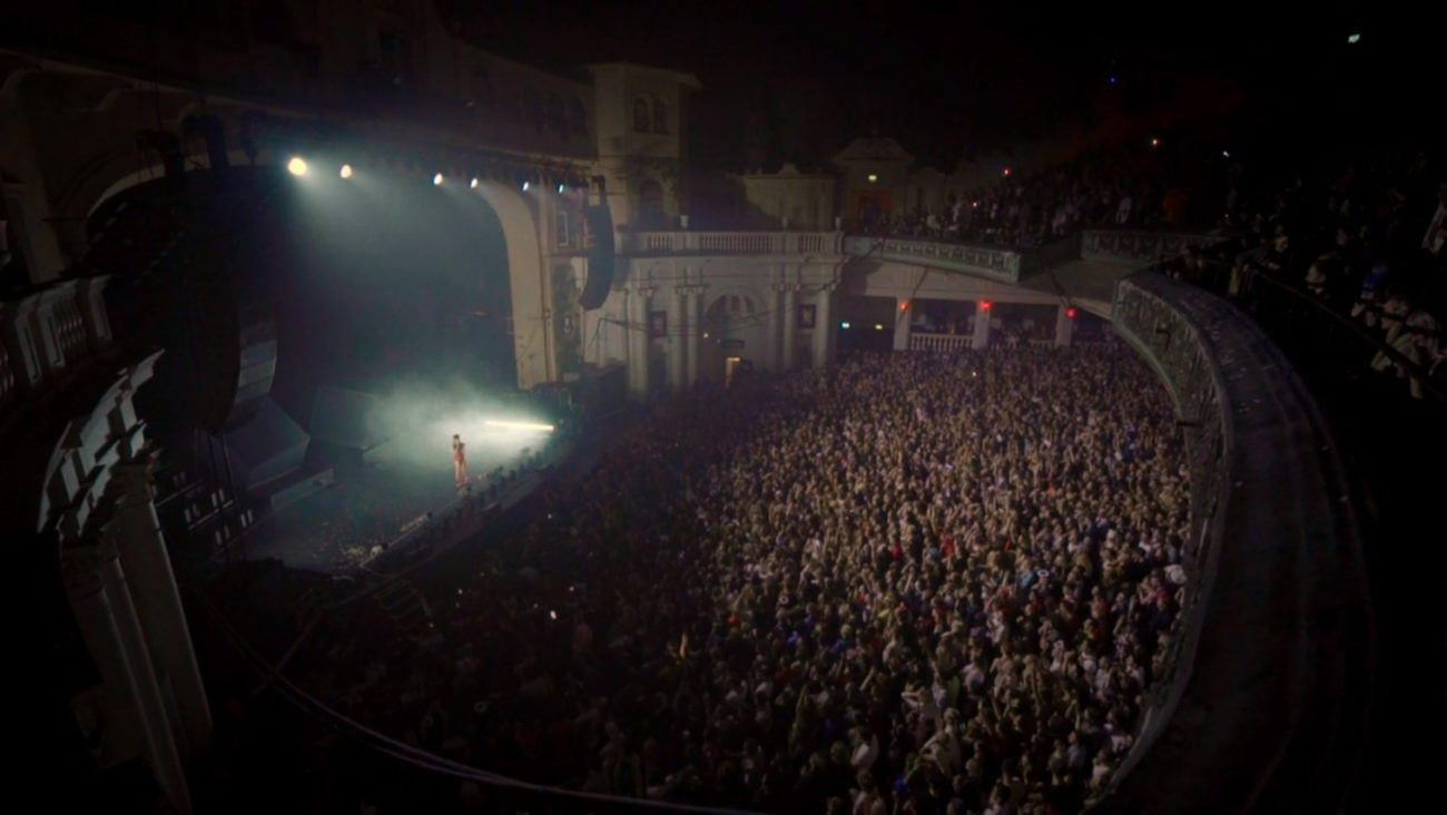 From Alone Together: Charli XCX performs in front of a filled theater venue.