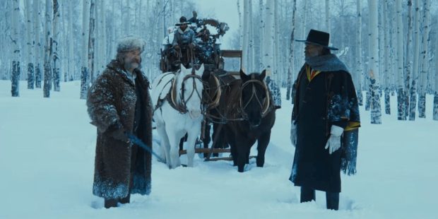 John Ruth (Kurt Russell) and Major Marquis Warren (Samuel L. Jackson) get into an argument during a snowstorm in THE HATEFUL EIGHT.