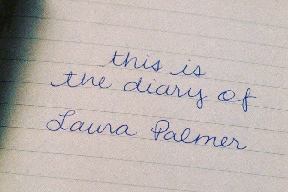 "this is the diary of Laura Palmer" written in cursive on a white piece of paper