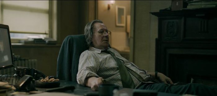 Jackson Lamb reclines in his office chair in Slow Horses S1E2