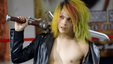 Kidd Bandit poses with a sword behind his neck