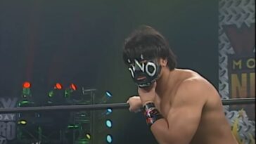 The Great Muta hunches in the corner of the ring