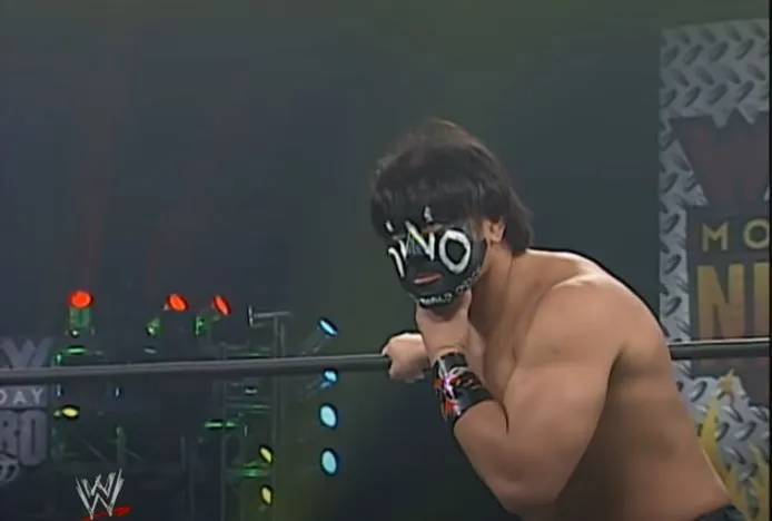 The Great Muta hunches in the corner of the ring