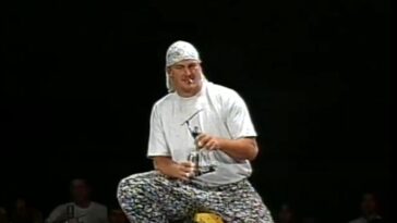 Mikey Whipwreck sits on a ladder
