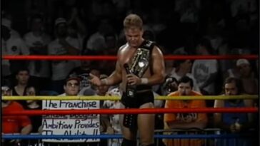 Shane Douglas stands in the ring with a belt over his shoulder