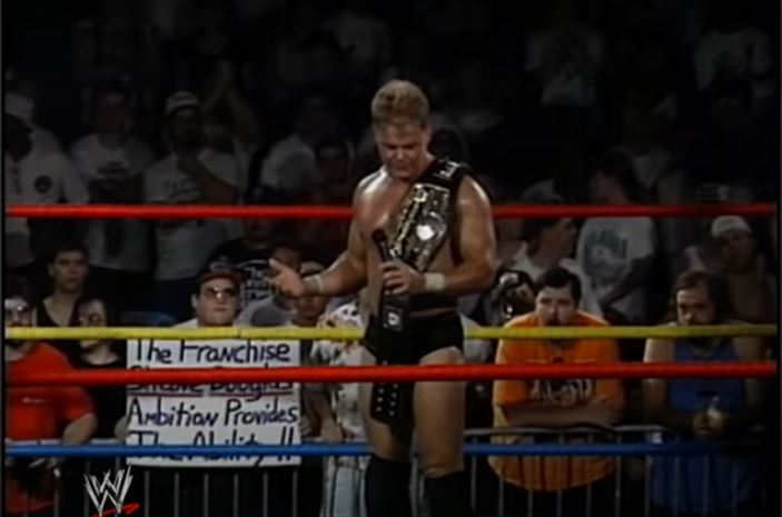 Shane Douglas stands in the ring with a belt over his shoulder