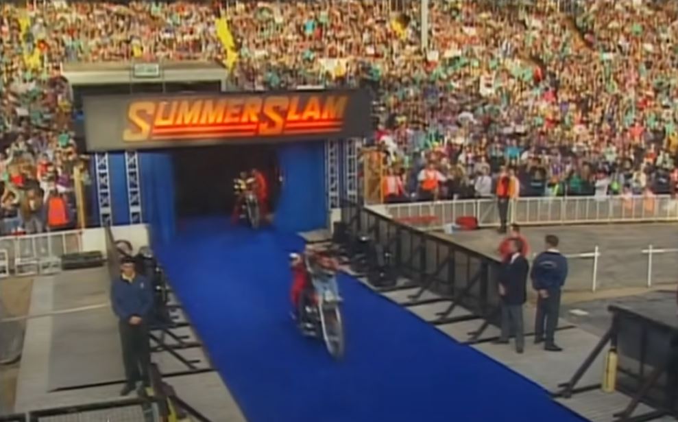 Men on motorcycles under a sign that reads SummerSlam