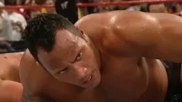 The Rock lies on the mat looking upwards