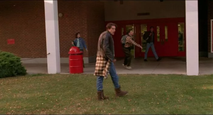 Bobby Briggs moving toward high school, students dancing and looking upward.