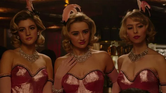 Candie, Mandie, and Sandie dressed in pink with feather fascinators.