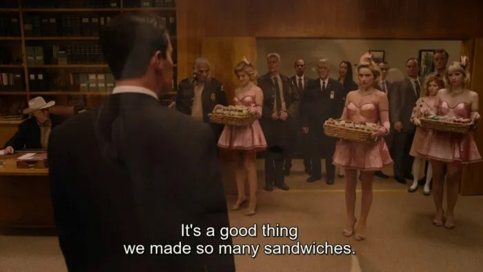 Candie, Mandie and Sandie holding baskets of sandwiches in the Sheriff's office.