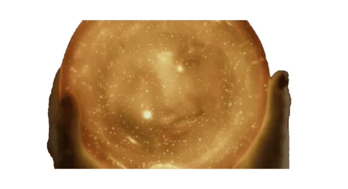 Pic of the orange-gold orb containing Laura's face, held by Senorita Dido's hands.