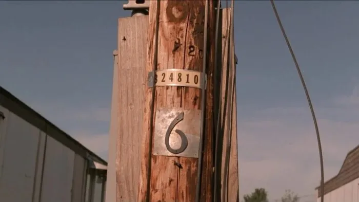 The utility pole with the number six on it.