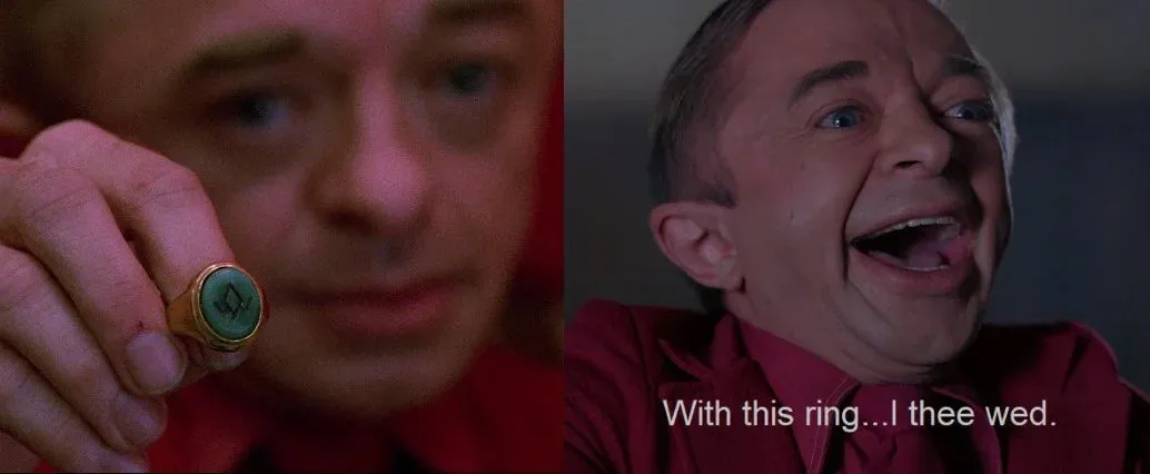 The Arm holding out the ring to Laura, next to The Arm saying "With this ring... I thee wed."