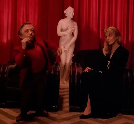 Laura watches The Arm dance in the Red Room.