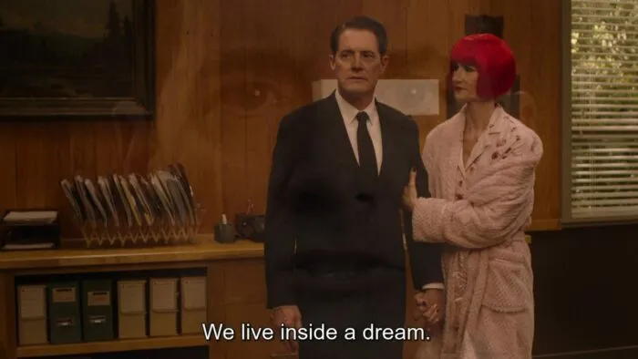 Diane holding Cooper's arm in Sheriff's office as Cooper's superimposed head says "We live inside a dream."