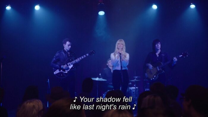 The Chromatics sing at the Roadhouse in Part 2.
