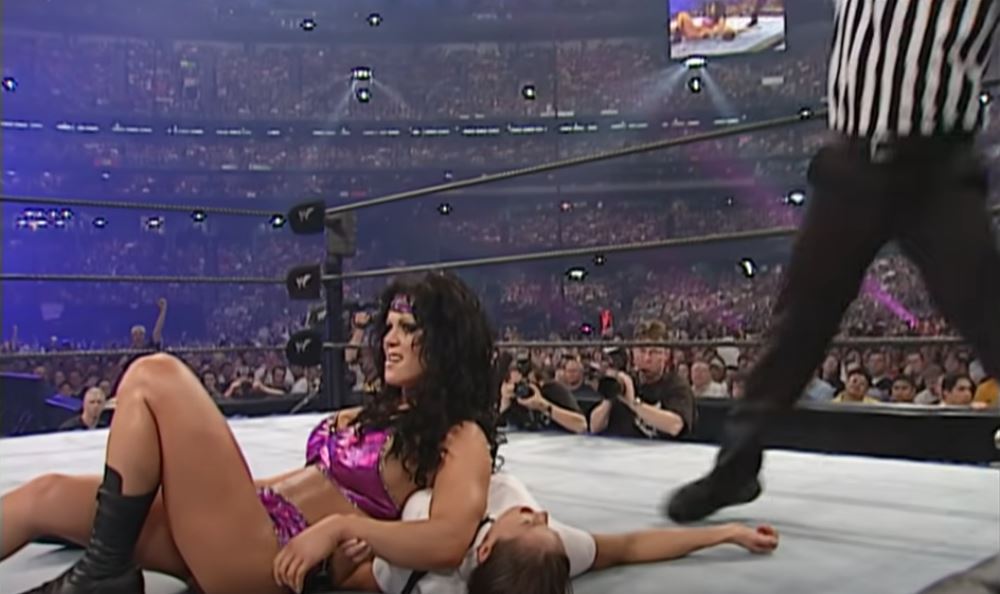 Chyna reclines against an opponent in the ring