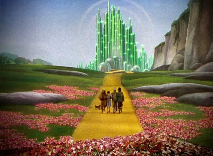 Dorothy and friends moving from the red and orange poppies down the yellow brick road to the Emerald City.