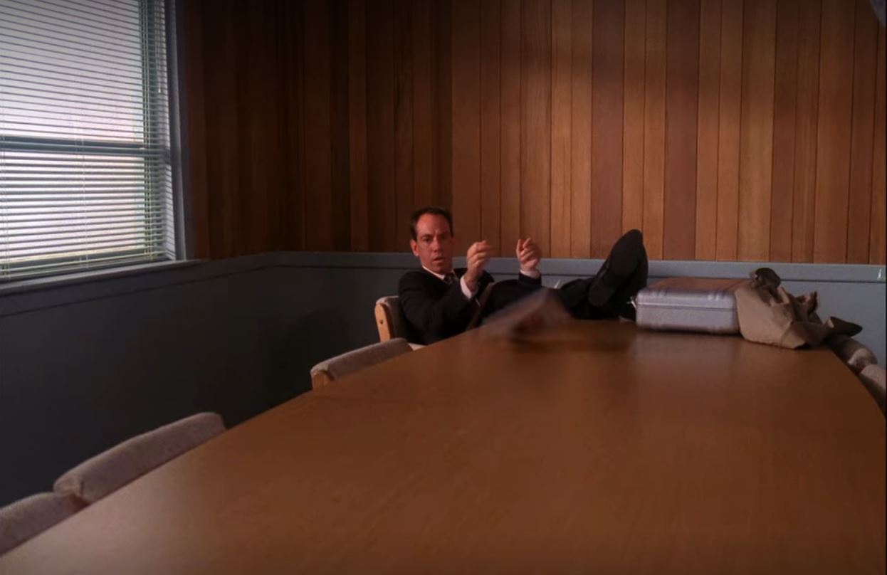 Albert sits with his feet up on the conference table in the Twin Peaks Sheriff's station