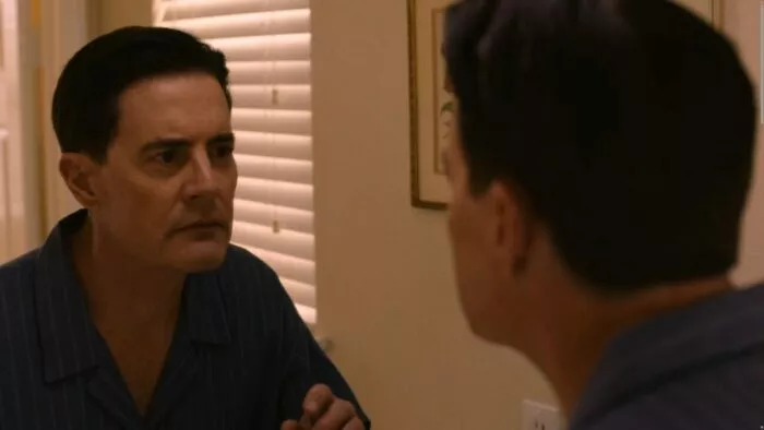 Cooper looking at himself in the mirror