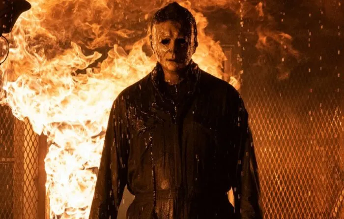 Michael Myers standing in front of a burning house in Halloween Kills.
