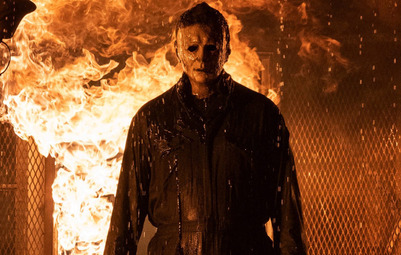 Michael Myers standing in front of a burning house in Halloween Kills.