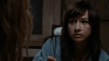 Danielle Harris sits at a table in Halloween 2.