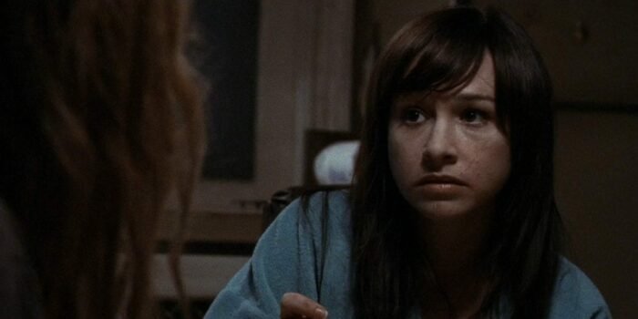 Danielle Harris sits at a table in Halloween 2.