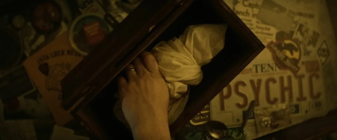 Taking the statue out of the box in The Unbinding