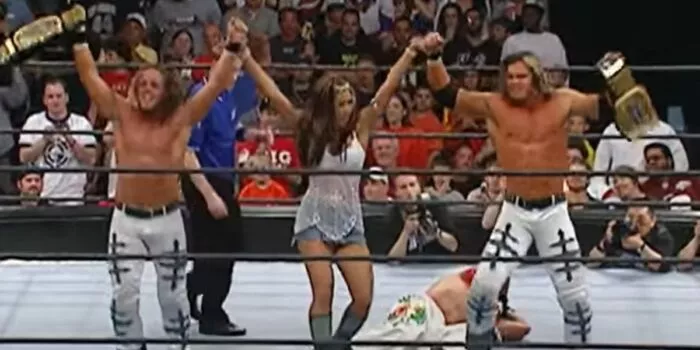 MNM stand over a beaten Rey Mysterio