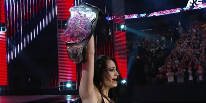 Paige celebrates her first main roster title win.