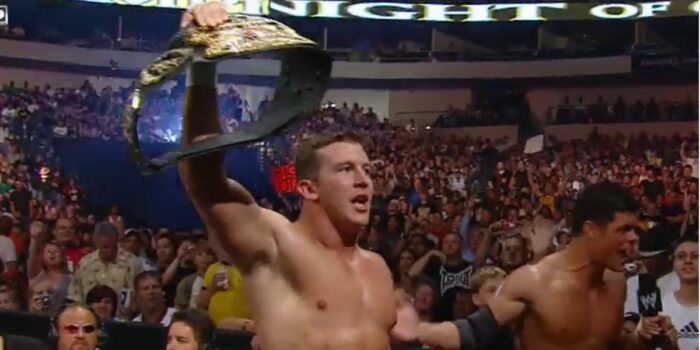 Ted Dibiase, Jr. holds aloft the belt just won in his WWE debut.